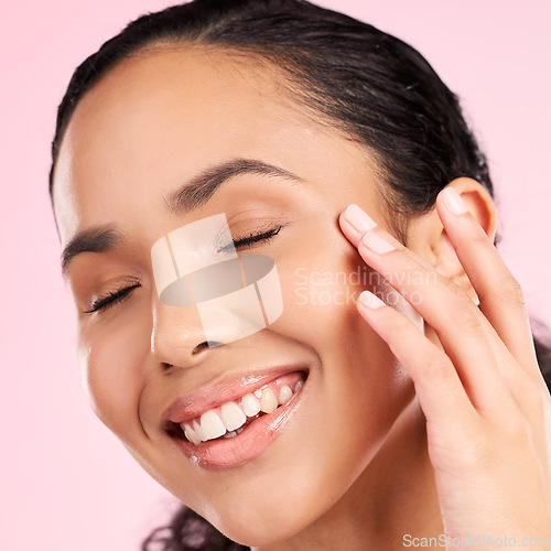 Image of Beauty, skin cream and face of a woman in studio for cosmetics, dermatology and glow. Headshot, moisturizer and natural skincare of a young female aesthetic model on a pink background with a smile