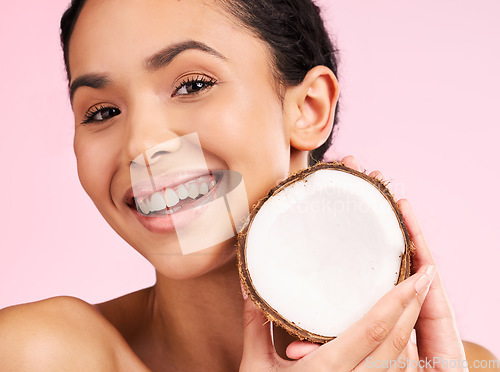 Image of Woman face, coconut fruit and beauty, healthy skincare or vegan cream on pink studio background. Portrait of Mexican person in natural product for dermatology, eco friendly cosmetics and oil benefits