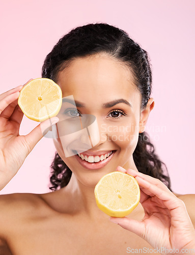 Image of Woman, skincare and lemon in studio portrait for smile, happiness or natural skin glow by pink background. Mexican model and fruit for cosmetics, youth or detox for wellness, nutrition and shine