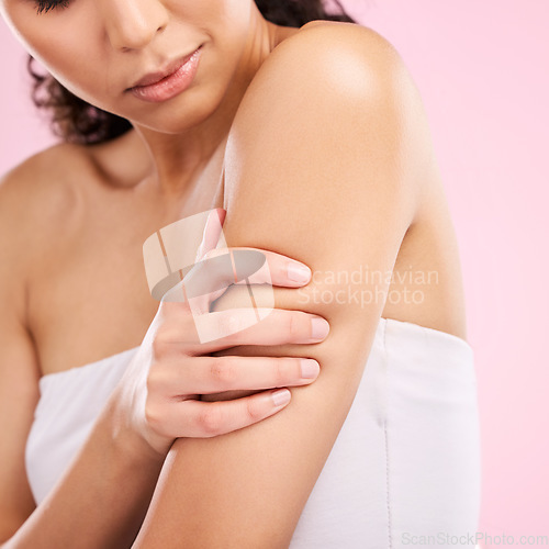 Image of Beauty, skin care and arm of a woman in studio for dermatology, cosmetics and hygiene. Health, wellness and clean body of a female aesthetic model on a pink background for glow, shine and moisturizer