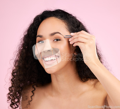 Image of Face, smile and woman with tweezer for eyebrow beauty in studio isolated on a pink background. Natural portrait, facial plucking or hair removal of model for self care, cosmetic wellness or aesthetic