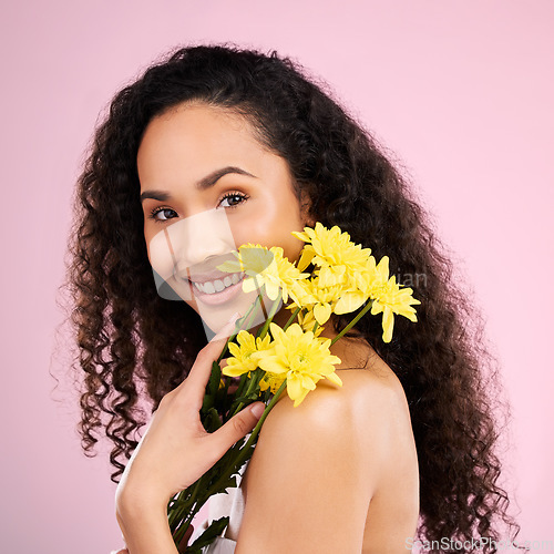 Image of Flowers, face and skincare of happy woman in studio isolated on a pink background. Portrait, smile or beauty model with plant, floral cosmetics or natural organic treatment for healthy skin aesthetic