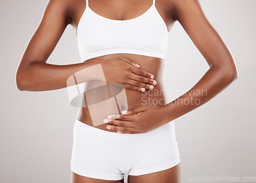 Image of Body, hands and stomach of a woman for health and wellness on a white studio background. Fitness, gut and diet of aesthetic female model for weight loss, colon balance or digestion and motivation