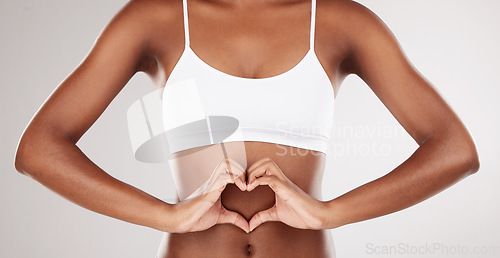 Image of Body, heart and stomach of a woman for health and wellness on a white studio background. Fitness, gut and diet of aesthetic female model for weight loss, balance or digestion with hands or love emoji