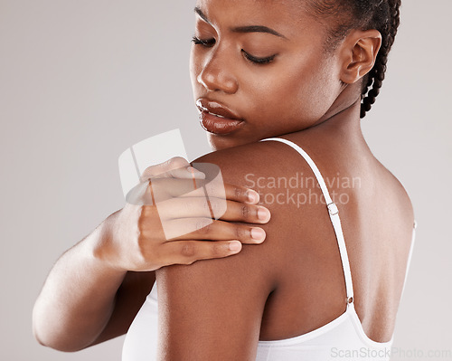 Image of Black woman, shoulder pain and injury with health risk, muscle tension and stress on a grey studio background. Female person, inflammation or model with joint strain, sore and swollen with body ache