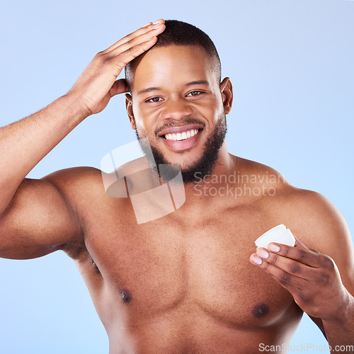 Image of Health, portrait and a black man with cream for hair care, shine and moisture on a studio background. Happy, wellness and an African person or model with gel for growth isolated on a backdrop