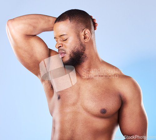 Image of Man, armpit and bad smell in studio for body odor, deodorant and cleaning for skincare. Black male model, underarm and stink from sweating, dirty hygiene and personal grooming on blue background