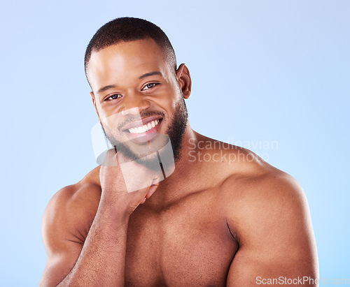 Image of Cosmetics, portrait and black man with skincare, muscle and wellness against a blue studio background. Male person, model and guy with treatment, face and glow with dermatology, aesthetic and health