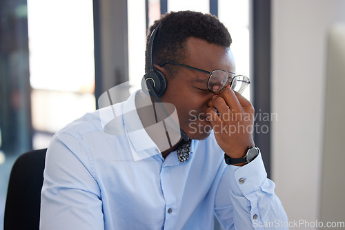 Image of Customer support, call center burnout or black man stress over communication mistake, networking problem or anxiety. Fatigue, tired or African insurance agent, person or consultant with headache pain