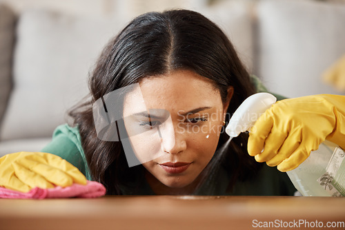 Image of Face, spray bottle and a woman cleaning a wooden surface in her home for hygiene or disinfection. Gloves, product or bacteria and a cleaner with focus using detergent to spring clean in an apartment