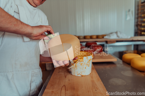 Image of Cheese maker working in the industry for manual production of homemade cheese