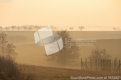 Image of Spring foggy and misty sunrise landscape