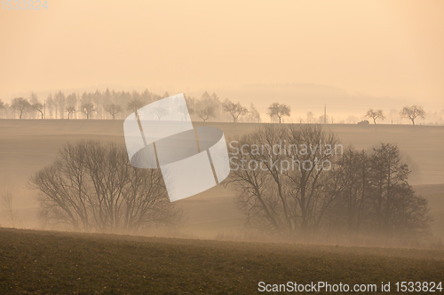 Image of Spring foggy and misty sunrise landscape