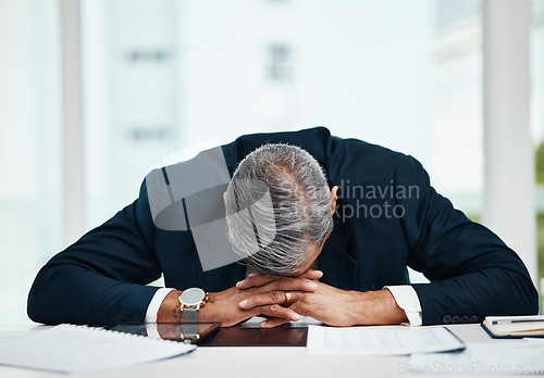 Image of Burnout, professional and senior man sleeping at desk with tech or problem with fatigue in office. Tired, stress and senior male person asleep on table with insomnia at workplace at workplace.