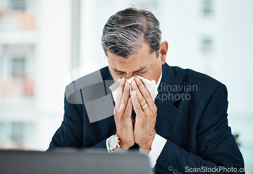 Image of Mature business man, blowing nose and sick with allergy, covid or virus in company office. Professional, tissue paper and manager with allergies for health problem, cold fever and bacteria in winter