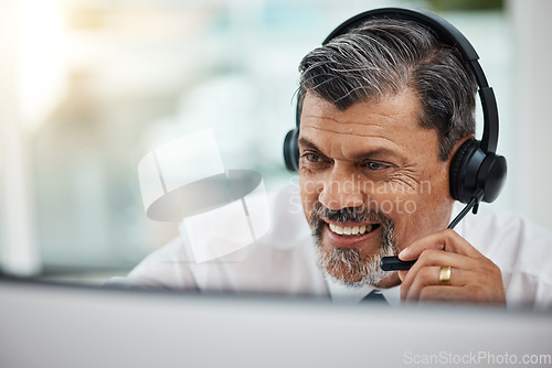 Image of Happy, call center and mature man listening for business, customer service or support. Contact us, telemarketing and professional smile, sales agent or crm consultant working at help desk in office