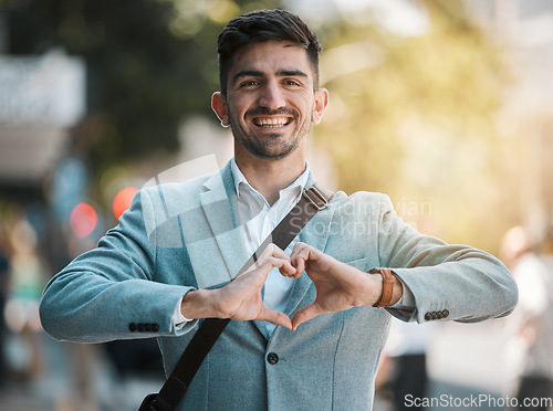 Image of Hands in heart, business and portrait of man in city for support, startup goals and kindness in street. Travel, professional job and face of male worker with love emoji for career, working and job