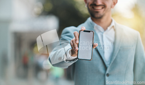 Image of Hand, blank phone screen and space in street with happy business man for app mockup, promotion or branding. Smartphone, entrepreneur and smile for ux, iot logo or mobile web design on metro sidewalk