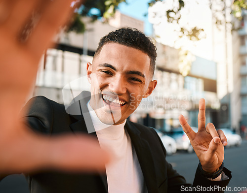 Image of Selfie, peace sign and portrait of business man in city for social media, profile picture and post. Travel, professional and face of male worker with hand gesture excited for career, job and success