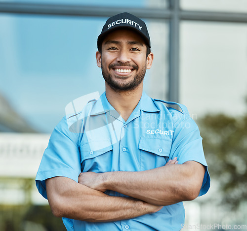 Image of Asian man, portrait and security guard with arms crossed in city for career safety or outdoor protection. Male person, police or officer smile in confidence, law enforcement or patrol in urban town