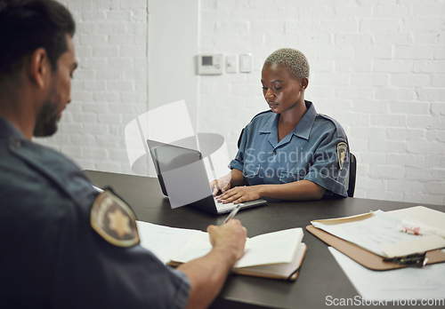 Image of Police team, investigation and documents for filing report or working on case together at precinct. Man and woman, cops or law enforcement busy on paperwork in security, arrest or crime with evidence