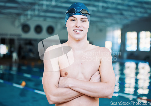 Image of Swimming, sports and portrait of man by pool for training, competition and exercise in gym. Professional, fitness and male swimmer with crossed arms for challenge, workout and practice for wellness