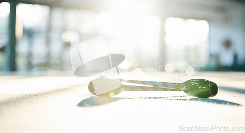 Image of Fitness, dance and ribbon on the floor of a gym or studio for training with flare on a blurred background. Exercise, creative and equipment with a baton for dancing in an empty health center closeup