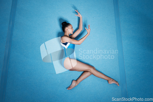 Image of Above, dance and a woman for gymnastics on the floor, training and doing a professional routine. Creative, art and a young girl or athlete gymnast dancing for a competition, doing ballet or talent