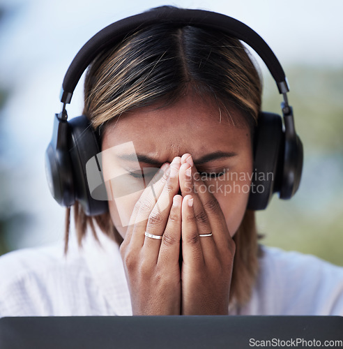 Image of Call center, stress and female customer service consultant working on an online consultation. Burnout, migraine and professional woman telemarketing agent with a headset for crm crisis in the office.