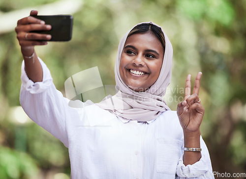 Image of Selfie, peace sign and student with muslim woman in park for social media, relax and happy. College, smile and happiness with female person in nature for profile picture, blog and gen z post