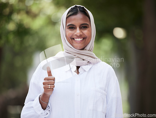 Image of Thumbs up, happy and portrait of Muslim woman in park for support, agreement and yes outdoors. Happiness, smile and face of Islamic female person with hand sign for approval, thank you and success