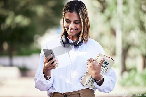 Image of Woman, phone or student with books in park outdoor for communication, music or chat. Social media, research and a happy young female person in campus nature with a smartphone connection and education