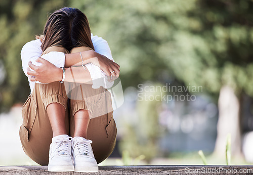 Image of Sad, cry and student with woman in park for depression, frustrated and stress. Mental health, anxiety and fear with female person in nature for psychology, tired and fatigue with mockup space