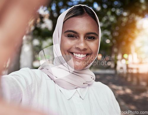 Image of Selfie, happy and portrait of Muslim woman in park for holiday, freedom and relax outdoors. Social media, hijab and face of Islamic female person with smile for picture, memories and post in nature