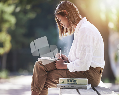 Image of Woman, writing and student with books at park outdoor to study for future in business management. Studying, learning or knowledge of a young female person in nature with notebook for school education