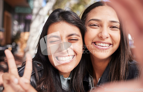 Image of Face, friends and selfie in city with peace sign, smile and bonding together outdoor for travel. Portrait, profile picture and girls or women with photography for happy memory, social media or v hand