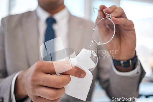 Image of Lens, man and cleaning and glasses with hand or fabric in office to wipe dirt in blurry background. Professional, prescription and maintenance with cloth for person with eye care or clear vision.