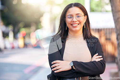 Image of Portrait, designer and woman with arms crossed in city, urban street or outdoor. Face, glasses and confidence of creative professional, employee smile and happy worker from Brazil for business career