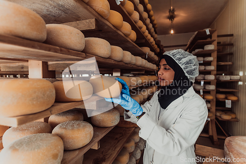 Image of Arab investor in a warehouse of the cheese production industry