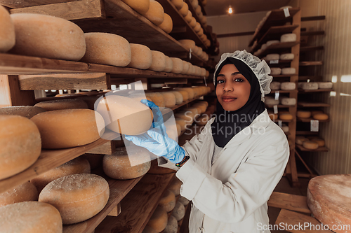 Image of Arab investor in a warehouse of the cheese production industry