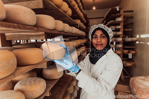 Image of Arab investor in a warehouse of the cheese production industry