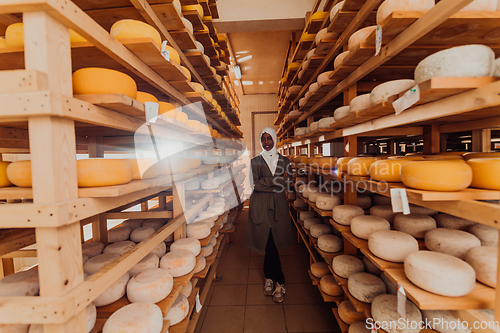 Image of Arab investor in a warehouse of the cheese production industry