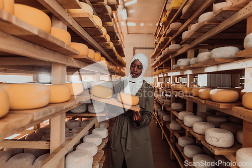 Image of Arab investor in a warehouse of the cheese production industry