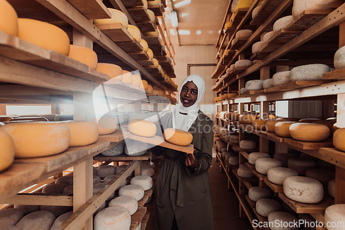 Image of Arab investor in a warehouse of the cheese production industry