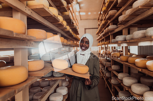 Image of Arab investor in a warehouse of the cheese production industry