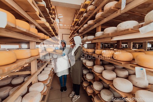 Image of Arab business partner visiting a cheese factory. The concept of investing in small businesses