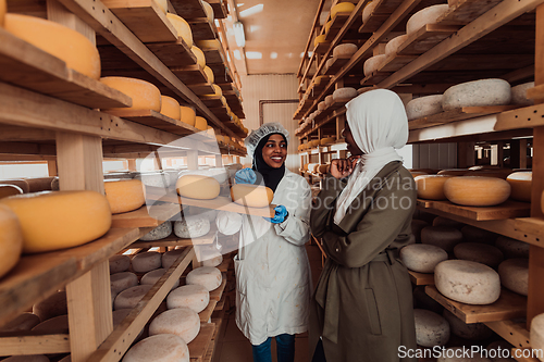 Image of Arab business partner visiting a cheese factory. The concept of investing in small businesses