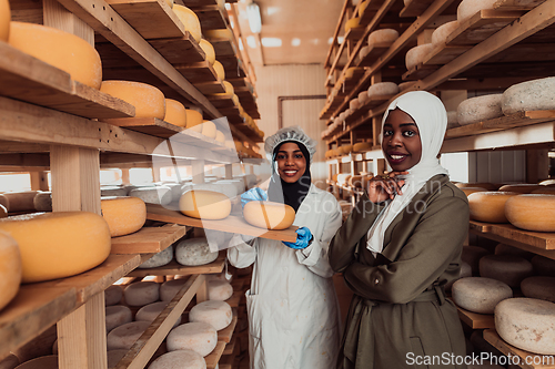 Image of Arab business partner visiting a cheese factory. The concept of investing in small businesses