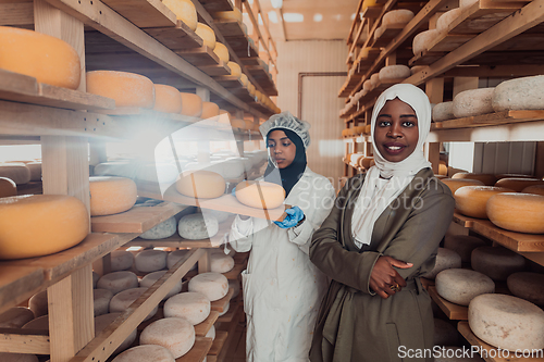 Image of Arab business partner visiting a cheese factory. The concept of investing in small businesses