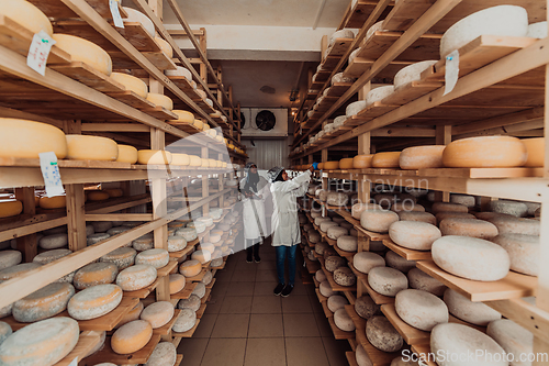 Image of Arab business partner visiting a cheese factory. The concept of investing in small businesses